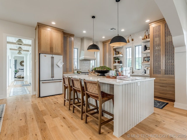 56 Center Ln N, Carlton Landing, OK 74432 - kitchen featuring high end fridge, open shelves, light countertops, light wood-style floors, and a kitchen island