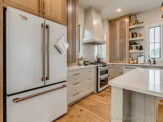 56 Center Ln N, Carlton Landing, OK 74432 - kitchen with white appliances, wall chimney range hood, backsplash, light countertops, and recessed lighting