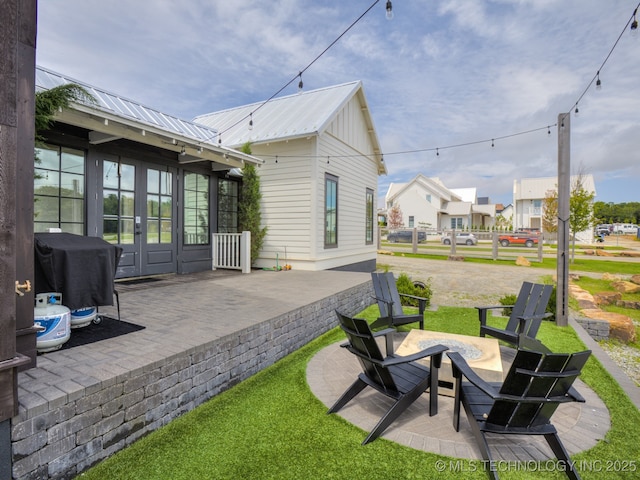 56 Center Ln N, Carlton Landing, OK 74432 - view of patio / terrace with french doors, area for grilling, a fire pit, and a residential view