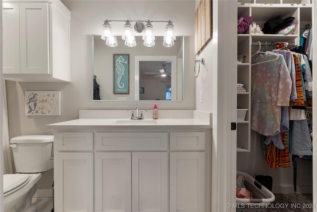 bathroom with vanity, ceiling fan, and toilet