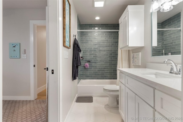 full bathroom featuring tiled shower / bath combo, vanity, tile patterned flooring, and toilet