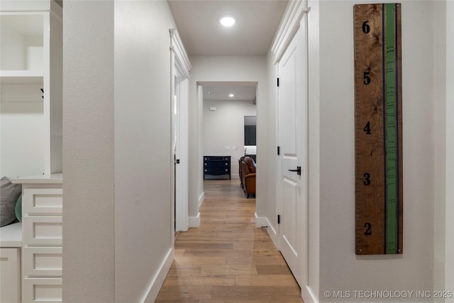 hall with light hardwood / wood-style floors