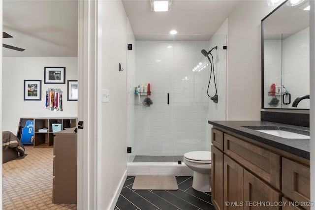 bathroom featuring tile patterned floors, toilet, an enclosed shower, and vanity