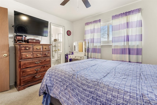 carpeted bedroom with ceiling fan and ensuite bathroom