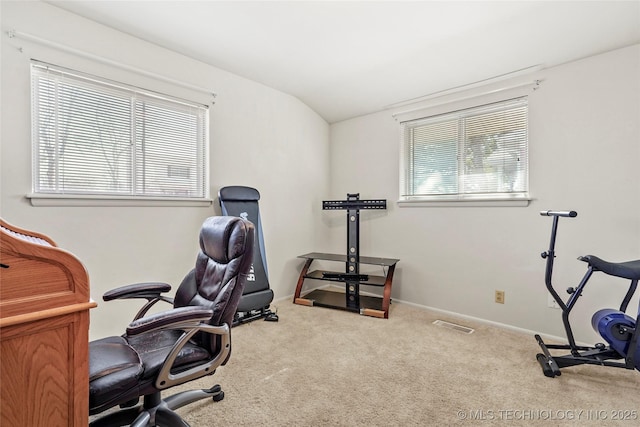 home office featuring light colored carpet and lofted ceiling