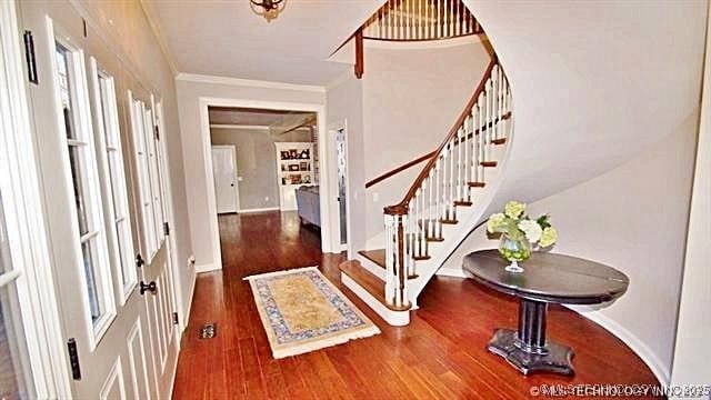 entryway featuring hardwood / wood-style floors and ornamental molding