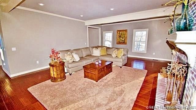 living room with crown molding and dark hardwood / wood-style floors