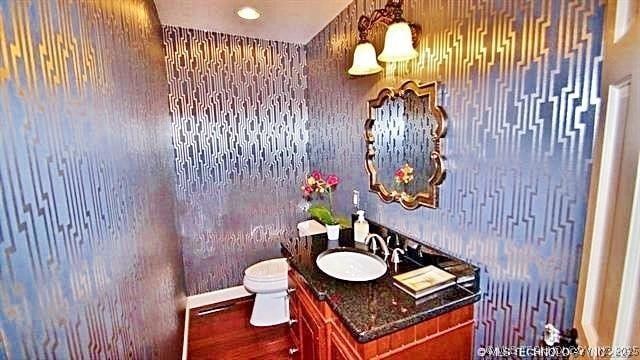 bathroom featuring hardwood / wood-style floors, toilet, and vanity