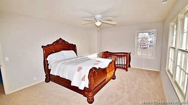 carpeted bedroom with ceiling fan