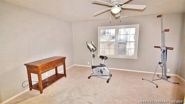 exercise area featuring carpet flooring and ceiling fan