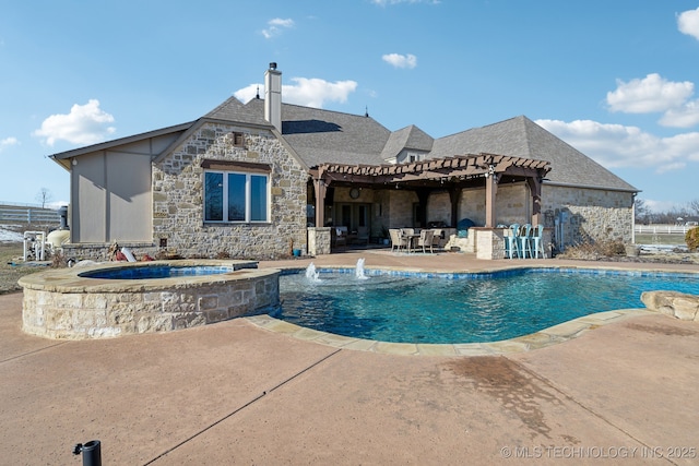 view of pool with a patio, pool water feature, an outdoor bar, and an in ground hot tub