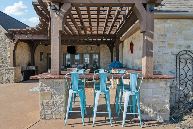 view of patio / terrace featuring exterior bar and a pergola