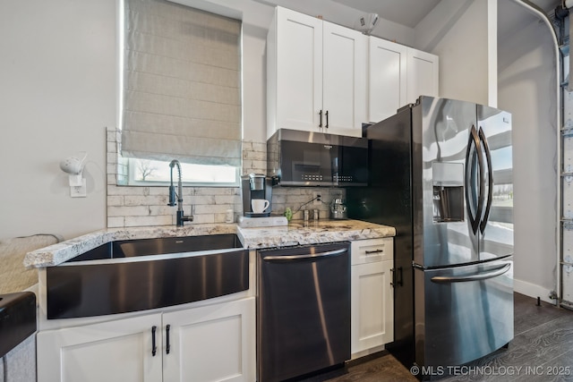 kitchen featuring sink, appliances with stainless steel finishes, white cabinetry, tasteful backsplash, and dark hardwood / wood-style flooring