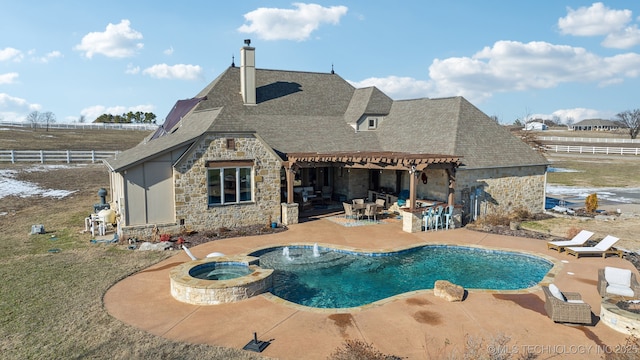 view of pool with an in ground hot tub, exterior bar, and a patio