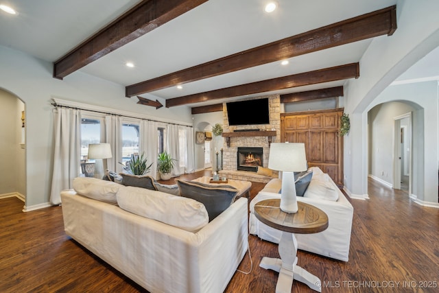 living room featuring dark hardwood / wood-style flooring, beam ceiling, and a fireplace