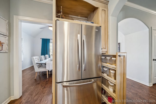 kitchen featuring lofted ceiling, stainless steel fridge, ceiling fan, dark wood-type flooring, and light brown cabinets