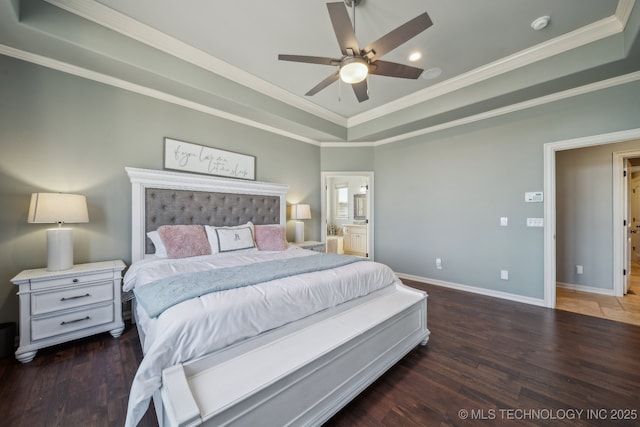 bedroom featuring a tray ceiling, ornamental molding, dark hardwood / wood-style floors, and ceiling fan