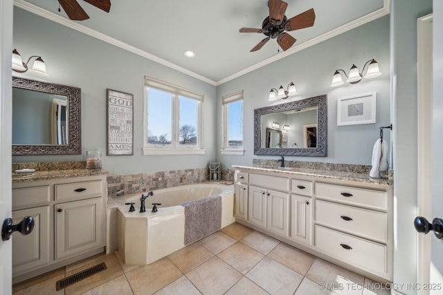 bathroom with crown molding, ceiling fan, tile patterned flooring, vanity, and a tub