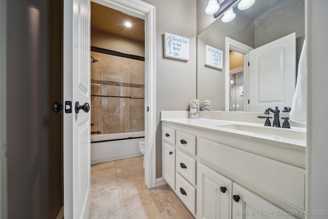 full bathroom featuring vanity, tile patterned flooring, toilet, and tiled shower / bath