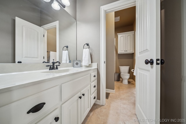 bathroom featuring vanity, tile patterned floors, and toilet