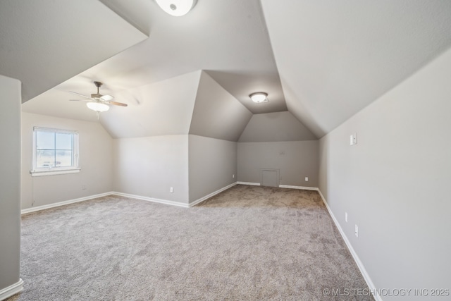 additional living space featuring ceiling fan, light colored carpet, and lofted ceiling