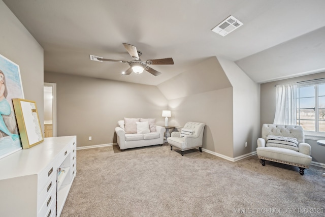 living area featuring light carpet, vaulted ceiling, and ceiling fan