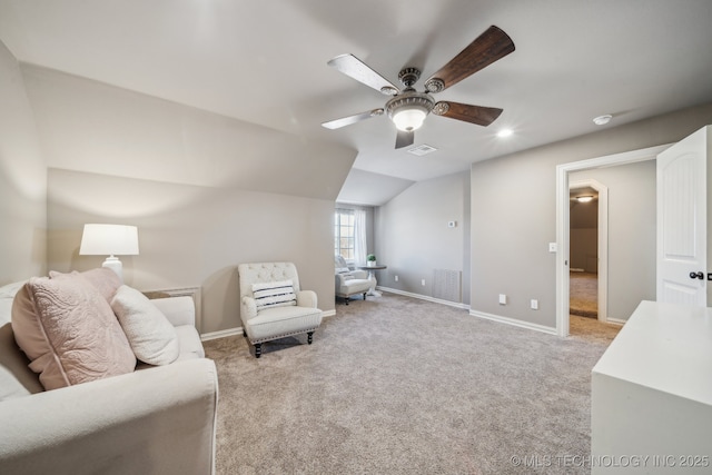 living area featuring vaulted ceiling, light carpet, and ceiling fan