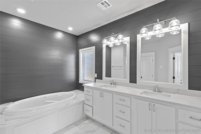 bathroom with vanity and a tub to relax in