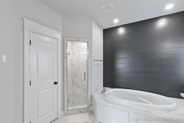 bathroom featuring shower with separate bathtub