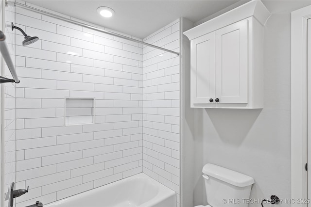 bathroom featuring toilet and tiled shower / bath combo