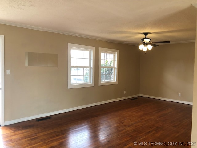 spare room with crown molding, ceiling fan, dark hardwood / wood-style flooring, and a textured ceiling