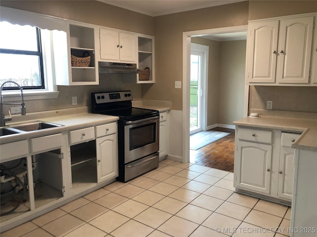 kitchen with sink, white cabinetry, stainless steel range with electric stovetop, light tile patterned floors, and ornamental molding