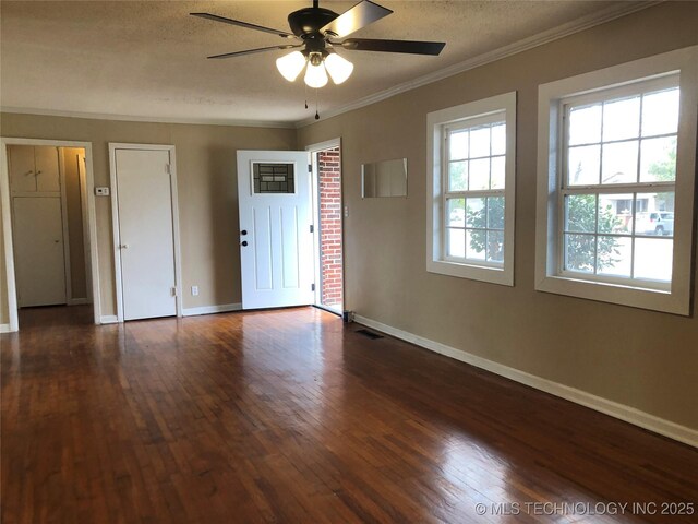 spare room with dark hardwood / wood-style flooring, crown molding, a textured ceiling, and ceiling fan