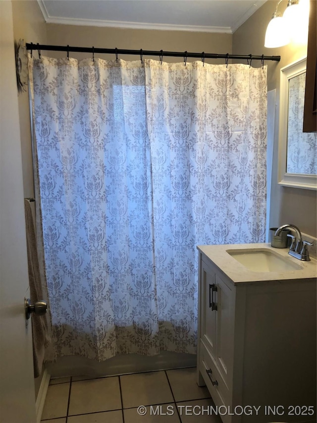 bathroom with crown molding, tile patterned floors, and vanity