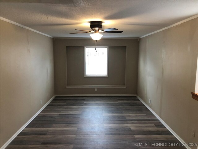 empty room featuring ceiling fan, ornamental molding, dark hardwood / wood-style floors, and a textured ceiling