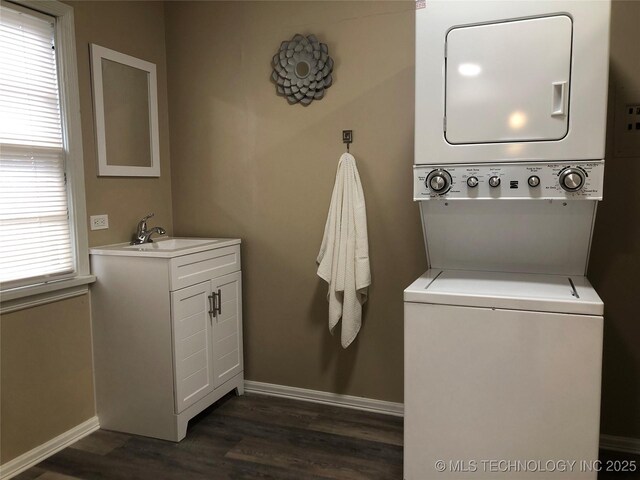 washroom with stacked washer and dryer, dark hardwood / wood-style flooring, and sink