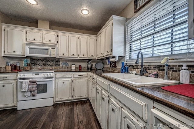 kitchen featuring white cabinetry, white appliances, sink, and a textured ceiling