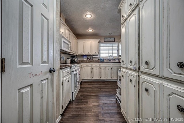 kitchen featuring electric stove, white cabinetry, dark hardwood / wood-style flooring, and a textured ceiling