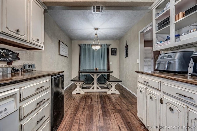 kitchen with dark wood-type flooring, pendant lighting, and a textured ceiling