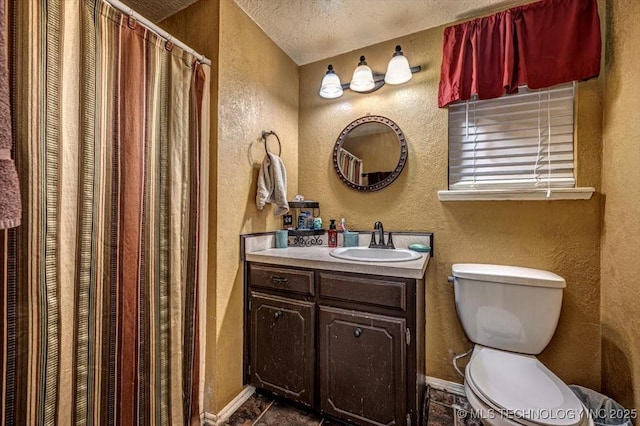 bathroom with vanity, tile patterned flooring, toilet, and a textured ceiling