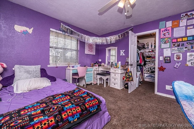 carpeted bedroom with a textured ceiling, a closet, and ceiling fan