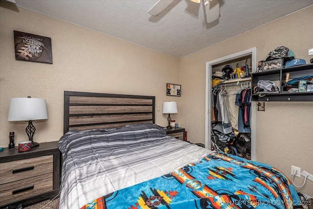 bedroom featuring a textured ceiling, a closet, and ceiling fan