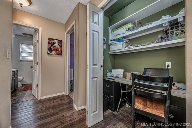 office space featuring dark wood-type flooring and a textured ceiling