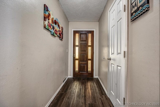 hall featuring hardwood / wood-style floors and a textured ceiling