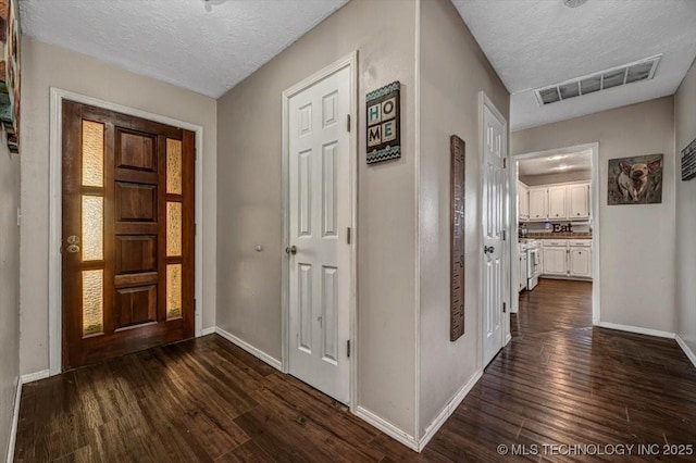 entryway featuring dark hardwood / wood-style floors and a textured ceiling