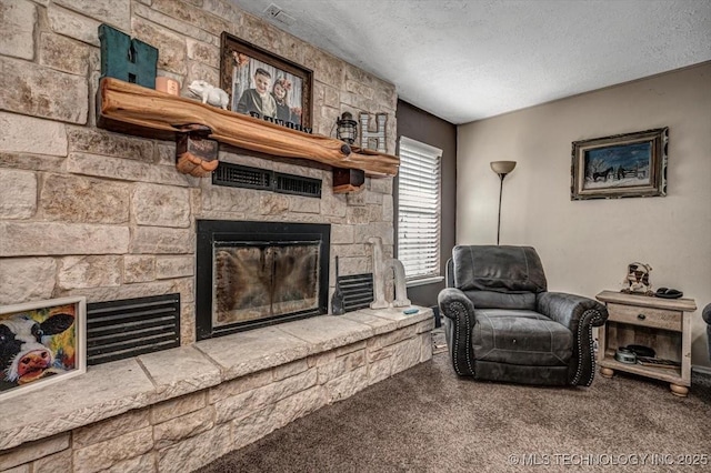 living area featuring a stone fireplace, carpet floors, and a textured ceiling