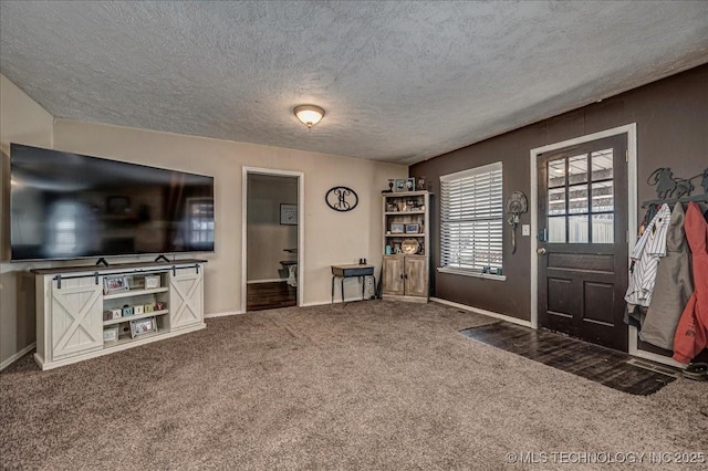 carpeted entrance foyer with a textured ceiling