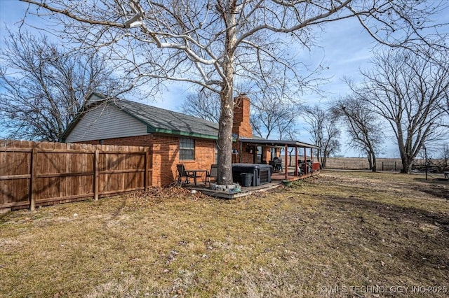 view of yard with a hot tub, cooling unit, and a patio area