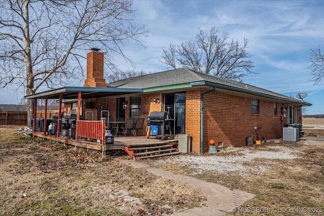 rear view of property with a deck and central air condition unit