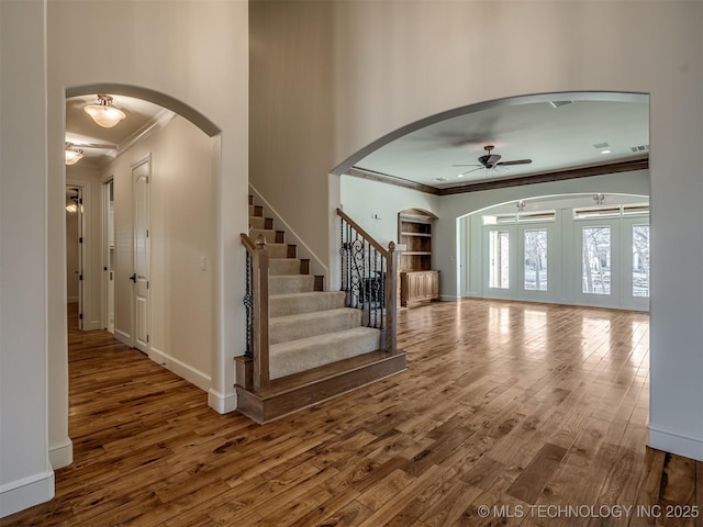 entryway featuring crown molding, ceiling fan, and hardwood / wood-style floors